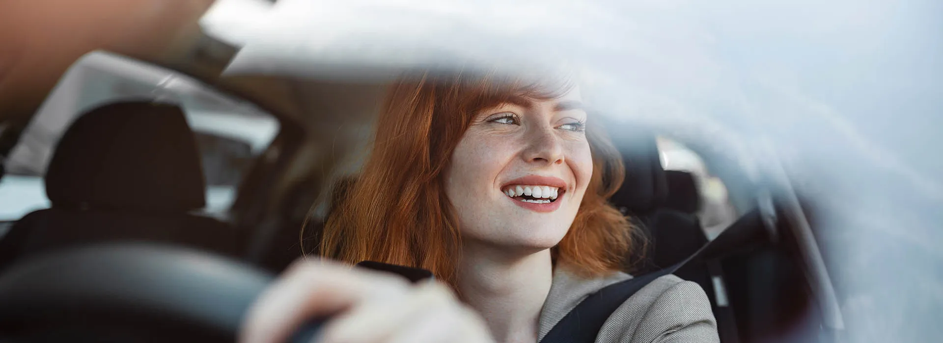 redheaded woman driving 